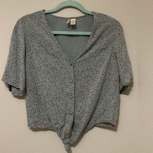 Blue shirt with pink flower print. Buttons down.